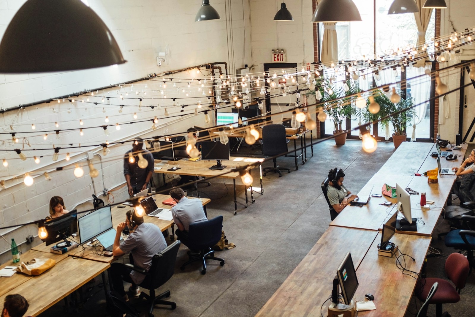 people with employee benefits sitting in front of computer monitors